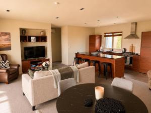 a living room with a table and a kitchen at Best high country retreat - Terrace Downs in Windwhistle