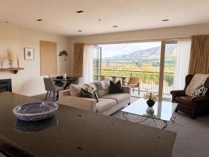 a living room with a couch and a table at Best high country retreat - Terrace Downs in Windwhistle
