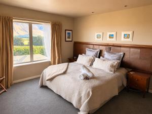a bedroom with a bed with a stuffed animal on it at Best high country retreat - Terrace Downs in Windwhistle
