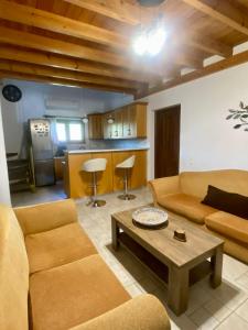 a living room with a couch and a table at BAREFOOT COTTAGE in Skiathos