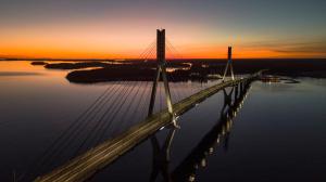a bridge over the water with a sunset in the background at Original Sokos Hotel Royal in Vaasa