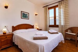 a bedroom with a bed with two towels on it at 045 Casa Embat ETV10796 by Mallorca Charme in Son Serra de Marina
