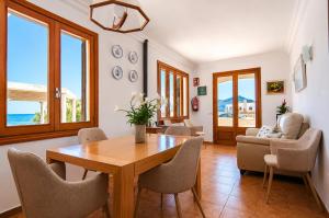 a living room with a wooden table and chairs at 045 Casa Embat ETV10796 by Mallorca Charme in Son Serra de Marina