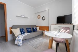 a living room with a couch and a table at Magdalena in Karwia