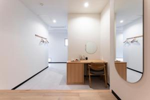 a dressing room with a desk and a mirror at KITAMAE BASE Kaga Hashitate in Kaga +64 photos