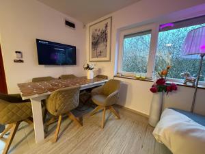 a room with a table and chairs and a tv at Orfű Hillside in Orfű