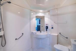 a white bathroom with a sink and a toilet at Quick Palace St Jean De Vedas - A709 in Saint-Jean-de-Védas