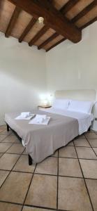 a white bed in a room with a wooden ceiling at Residence Villa Stufler in Modena