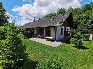 a small house with a patio in a yard at Apartmany Janosikove diery in Terchová