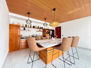a kitchen with a large wooden table and chairs at Villa Exquisite Central Seminyak by Nagisa Bali in Seminyak