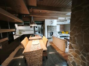 a kitchen and dining room with a table and chairs at Apartmany Janosikove diery in Terchová