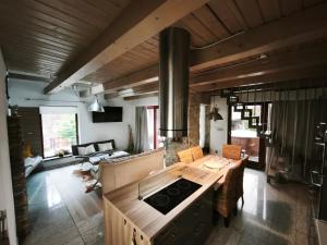 a kitchen with a table and a stove top oven at Apartmany Janosikove diery in Terchová