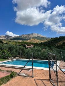 a swimming pool with a volley ball hoop at Casa Manila in Colmenar