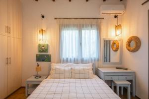 a small bedroom with a bed and a window at Panagea Holiday in Kitriaí