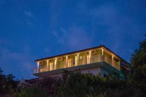 a building with lights on top of it at night at Amorosa Nest - Adults Only by Eutopia in Syvota