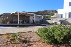 a villa with a swimming pool and a house at Villa Kairos in Angairiá +52 photos