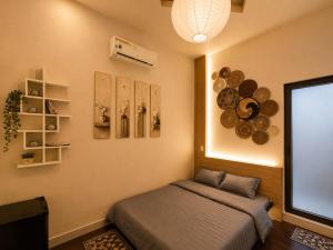a bedroom with a bed and a large screen at Spring Home 2 in Can Tho