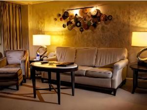 a living room with a couch and a table at Harrahs Hotel Reno in Reno