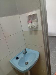 a bathroom with a blue sink in a room at GP StayIn in Lunas