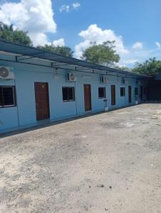 a building with blue walls and brown doors at GP StayIn in Lunas