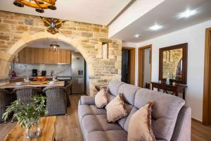 a living room with a couch and a kitchen at Traounou Serenity Villa Near to Afandou Beach in Afantou +18 photos