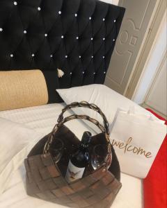 a bag with a bottle of wine and glasses on a bed at Paradise in Monemvasia
