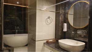 a bathroom with a sink and a toilet and a mirror at The Yasa Hotel In Gangtok in Gangtok +26 photos