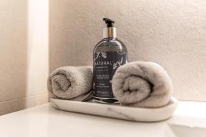 a bottle of soap and towels on a shelf in a bathroom at Ferienwohnung Grubgut in Taxenbach +56 photos