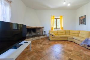 a living room with a couch and a fireplace at Casa Orizzonte Anglona in Nulvi