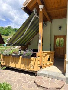 a house with a patio with plants on it at Apartma Arja in Spodnje Gorje