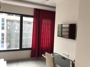 a room with a red curtain and a window at Tk Residence in İzmir