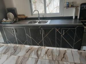 a kitchen with a sink and a window at Villa Ross in Saly Portudal