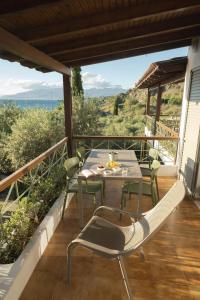 a patio with a table and chairs on a balcony at Panagea Holiday in Kitriaí