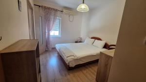 a small bedroom with a bed and a window at Villa Alla Bed and Breakfast in Herceg-Novi