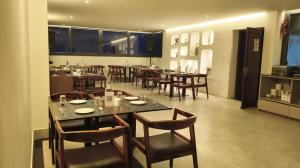 a dining room with tables and chairs in a restaurant at The Yasa Hotel In Gangtok in Gangtok