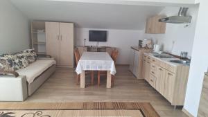 a small kitchen with a table and a couch at Villa Alla Bed and Breakfast in Herceg-Novi