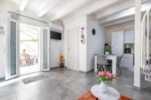 a living room with a table with flowers on it at Villa Angela in Nulvi