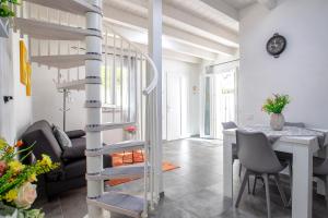 a spiral staircase in a living room with a table at Villa Angela in Nulvi