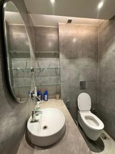 a bathroom with a sink and a toilet at THE MOONLIGHT STUDIo in Ghaziabad