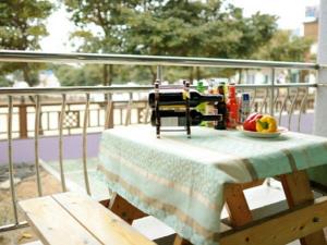 a table on a balcony with a plate of fruit on it at Namhae eunmorae pension in Namhae