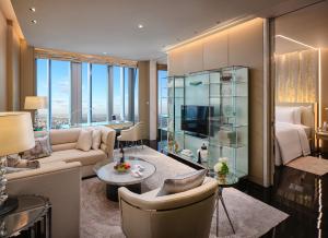 a living room with a couch and a bed and a television at J Hotel, Shanghai Tower in Shanghai