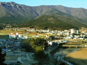 a view of a city with mountains in the background at Namhae eunmorae pension in Namhae