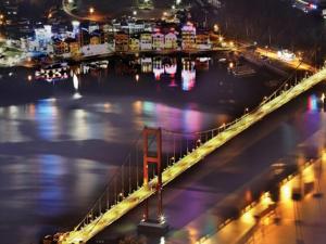 a bridge over a body of water at night at Namhae eunmorae pension in Namhae +2 photos