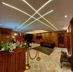 a living room with a couch and a red carpet at Hotel Hamza in Srinagar