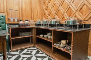 a kitchen with a counter with pots and pans at Hotel Hamza in Srinagar
