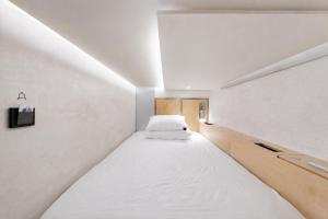 a small room with a large bed in it at At gangnam seoul in Seoul