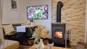 a living room with a wood burning stove at Auszeitplatzl in Unken +21 photos