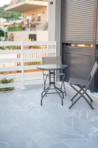 a table and a chair on a balcony at DNS Elements Apartments 1 in Nea Karvali
