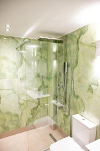 a bathroom with a glass shower with a toilet at DNS Elements Apartments 1 in Nea Karvali +29 photos