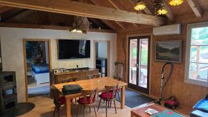 a living room with a wooden table and a television at aschis Lodge 2 in Soubey